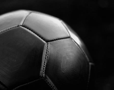 Black football on dark background