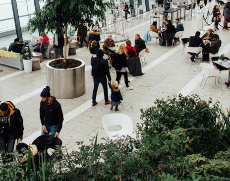 Green cafe space with people at Christmas