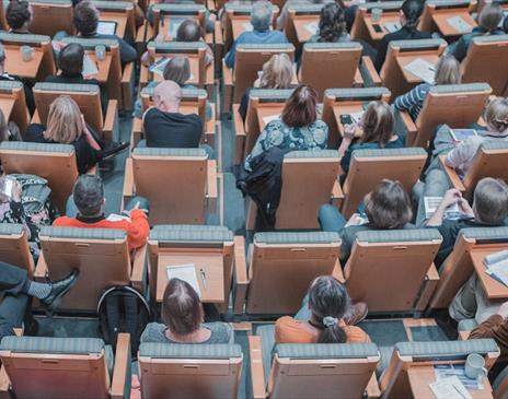 Individuals in busy conference