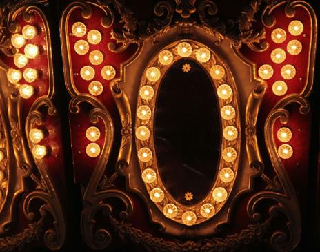 Elaborate gold and red mirror surrounded with yellow lights