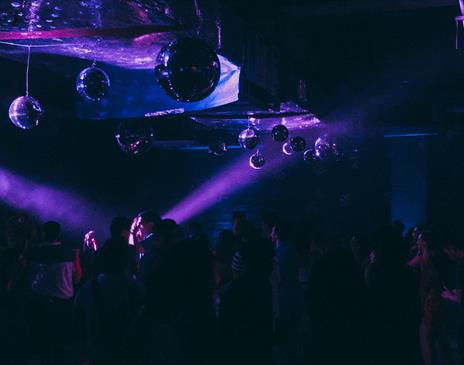 People dancing in purple club