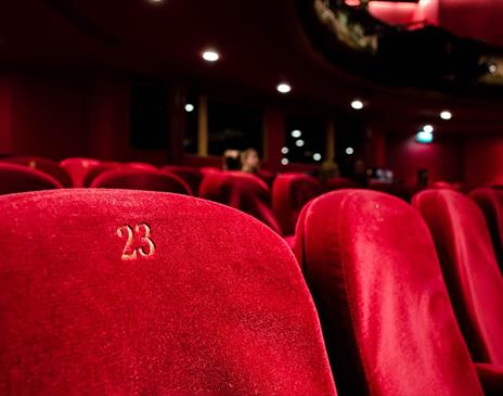 Red numbered seats at a theatre