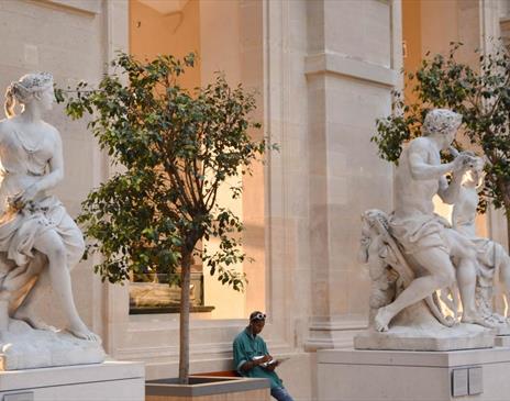 White marble statues outside museum