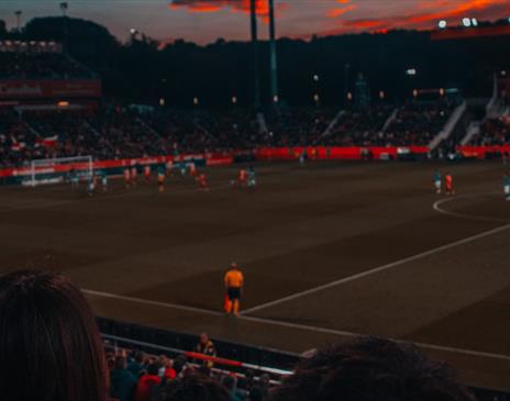 Football game at sunset in stadium