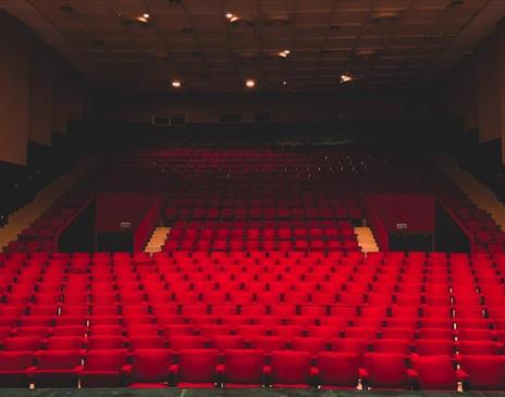 Empty red seats in a theatre