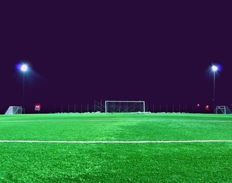 Empty football pitch at night with lights