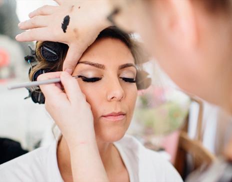Eyeliner expertly being applied to a model's eyes