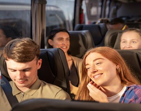 Happy travellers on a National Express coach.