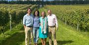 The Goring family who run the Wiston Estate, stood amongst the vines