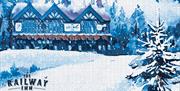 A nostalgic Christmas postcard showing the Railway Inn in the snow.