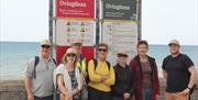 Walker in from of Ovingdean information board