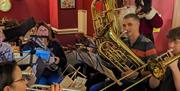 A festive brass band playing at The Railway Inn, one of them is dressed like Santa Claus