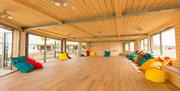 Inside shot of the Yellowave Beach House, a paneled room with views of the sea.