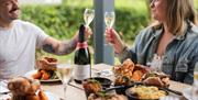 A couple enjoying a toast of sparkling Ridgeview wine.