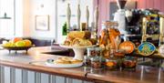 Delicious snacks sitting on the bar including sausage rolls and pastries.