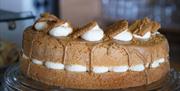 A large cake with Biscoff decorations on a countertop.