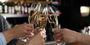 A group of people raising a glass of Champagne