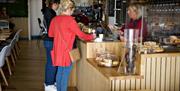 Customers at the counter buying lunch.