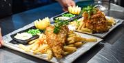 Plates of fish and chips ready to serve