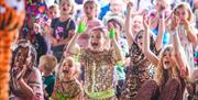 Children cheering whilst watching a performance at Elderflower Fields Festival.