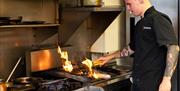 Flame grilled food in the kitchen at Bohemia.