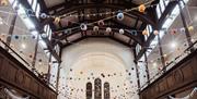 Round baubles are displayed across the ceiling of Fabrica Brighton