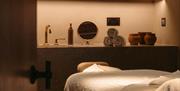 The edge of a bed within a treatment room at the Field Trip Spa, Brighton