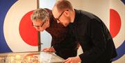 Two men looking at pinball machine