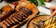 Dishes of delicious steak and sides at Kindling in Brighton