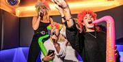 Lucky Voice - group of girls with inflatable saxophones