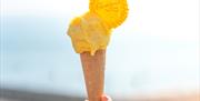 A lemon ice cream being held aloft