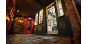 Red phone box in corner of a room