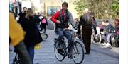 man cycling along New Road