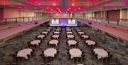 A room full of round tables ready to welcome guests at DoubleTree by Hilton Brighton Metropole
