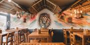 Image of a wall at the Coconut Island with a painted lion on it.