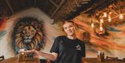 A friendly member of staff at The Coconut Island waiting to welcome visitors.