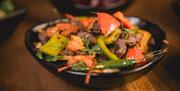 A tantalising curry topped with vibrant peppers