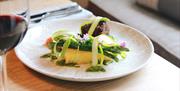 Plate of fresh asparagus served with courgette strips.