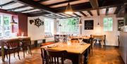 The dining room showing tables set with glassware and napkins.