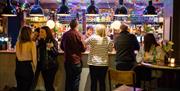 People ordering drinks at a bar