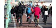 people cycling on the seafront cycle track