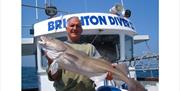 man holding up a cod