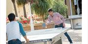 men playing table tennis at the Brighton Marina Village Square