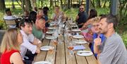 A group sitting to enjoy a wine tasting.