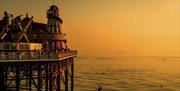 Brighton Palace Pier at sunset. Credit - VisitBrtiain