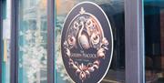The Golden Peacock logo