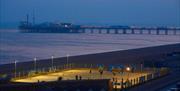 Yellowave Beach Sports Venue - court at night with Brighton Palace pier in background