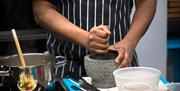 Preparing some spices in a pestle and mortal