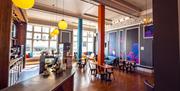 Bright and airy reception with contemporary wall art and beautiful old features