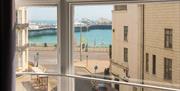A view out of a room in the hostel showing the sea beyond in the distance.